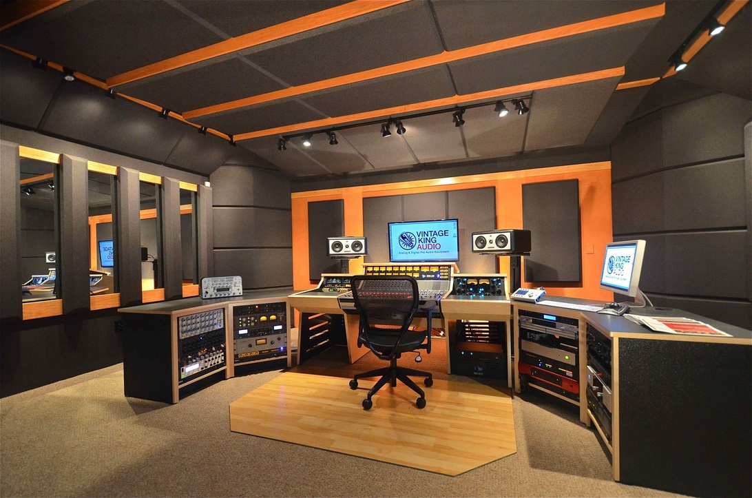 A professionally designed recording studio control room, complete with a large mixing console, studio monitors, and acoustic treatment panels, ready for audio production.
